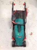 A Bosch Rotak 320 ER electric lawn mower with grass box and lead.