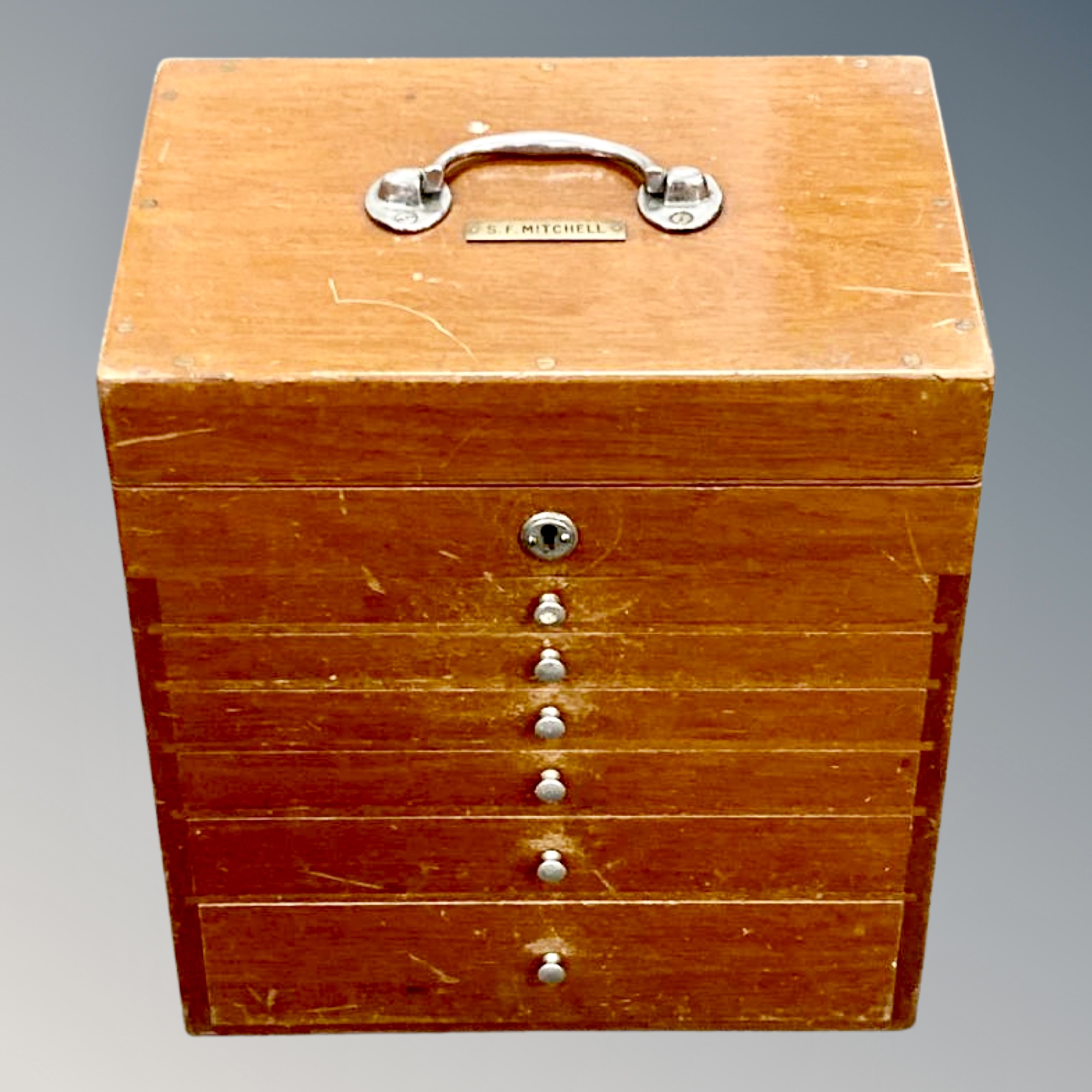A mid 20th century portable dentist's chest, fitted with six drawers and rising top section,