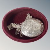 An engraved silver locket on chain. CONDITION REPORT: Inscription to reverse.