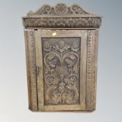 A 19th century carved oak wall cabinet.