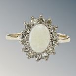 A 9ct yellow gold opal and diamond cluster ring, size O, 2.5g. CONDITION REPORT: 11.