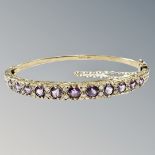 A 9ct gold amethyst and diamond bangle,