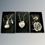 A silver rose pendant and matching ring, heart locket on chain,