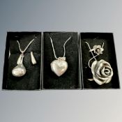 A silver rose pendant and matching ring, heart locket on chain,