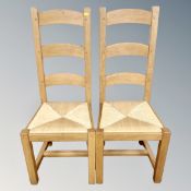 A set of six oak rush seated ladder back farmhouse chairs.