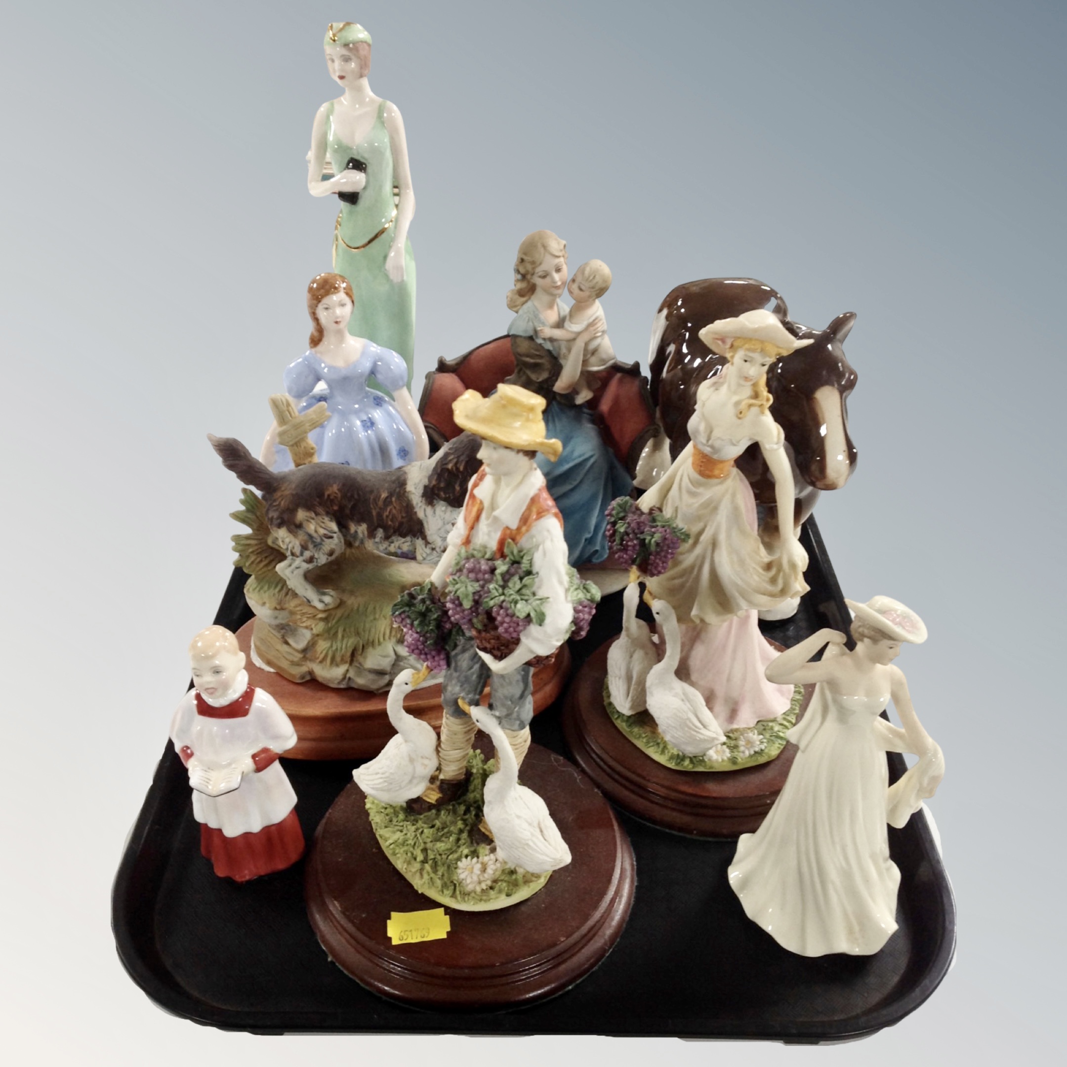 A tray containing assorted figurines to include Royal Doulton choir boy, Leonardo collection,