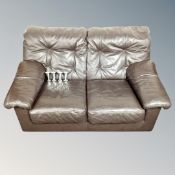 A brown leather two-seater settee.