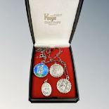 Four silver St Christopher pendants including an enamel example