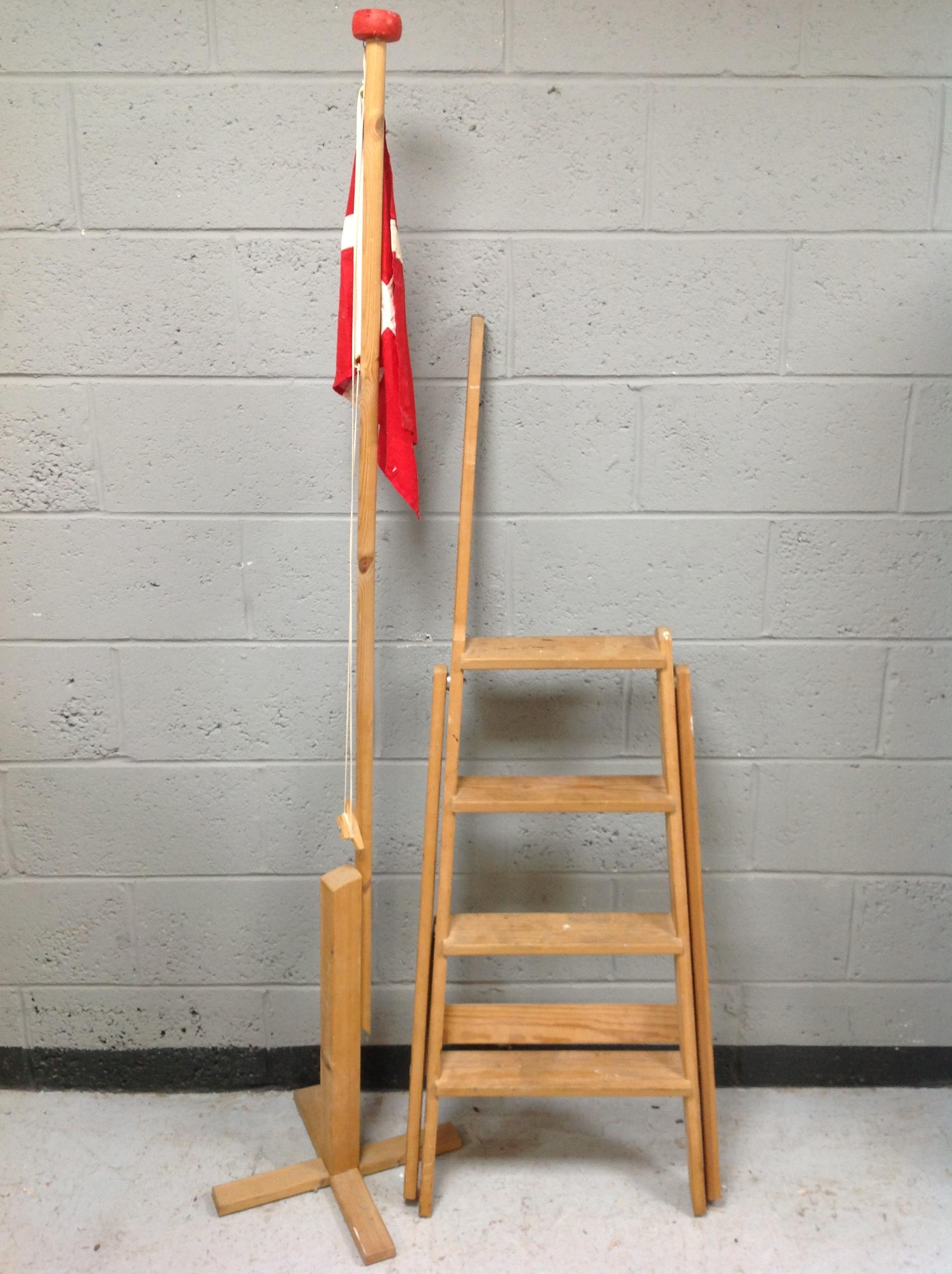 A set of vintage pine library steps together with a Danish flag and pole.