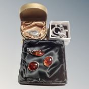 A group of silver jewelry including pendant, boltic amber earnings and pendant, locket on chain.