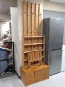 A pine six drawer low chest together with a pine wall mounted coat rack,