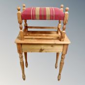 A pine side table fitted a drawer together with a pine upholstered foot stool.