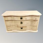 A 19th century pine serpentine fronted three drawer chest, height 67 cm, width 112 cm, depth 46 cm.