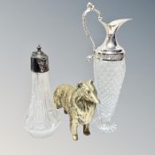A heavy brass figure of a dog, together with crystal and silver plated claret jug,