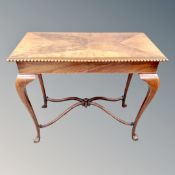 A late Victorian mahogany and walnut occasional table with under stretcher on paw feet