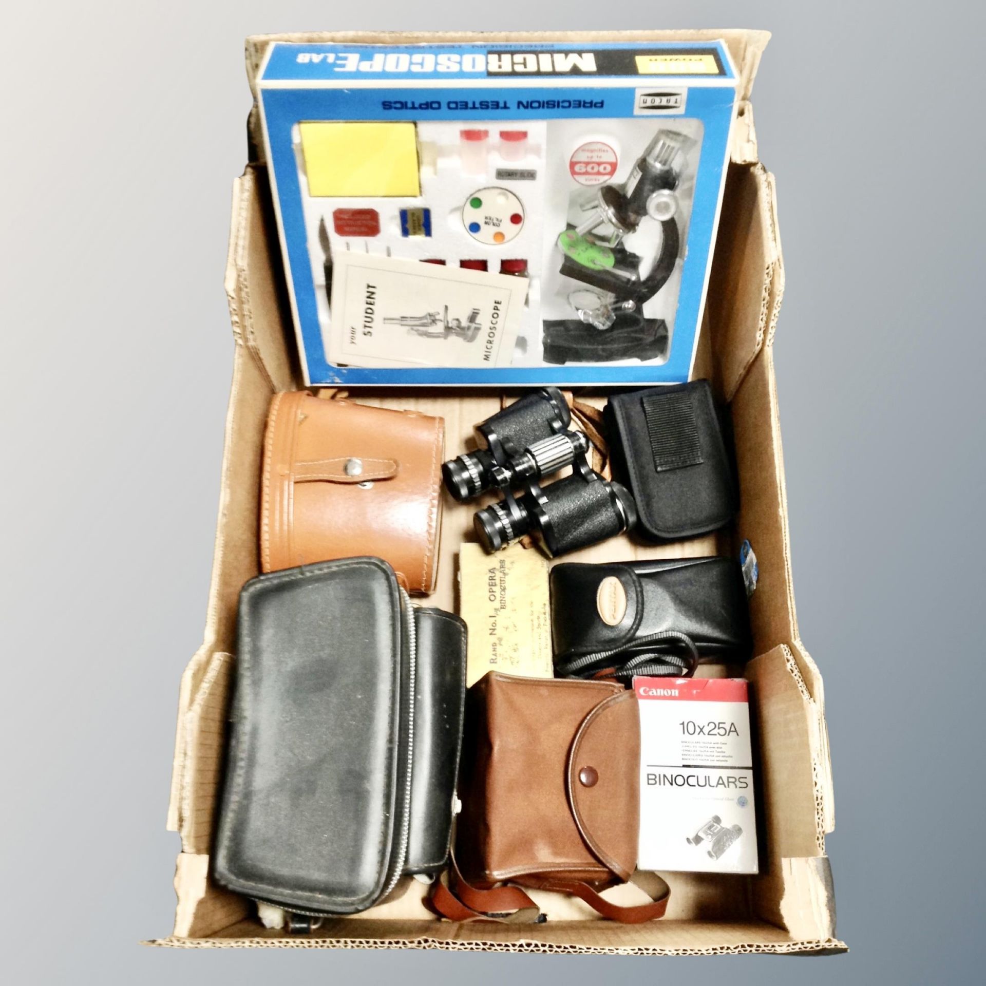 A box of Tasco student microscope set in original box, Frank 8 x 30 field glasses,