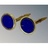 A pair of lapis lazuli cufflinks set in 14ct yellow gold.