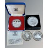 Silver proof coins including a crown, 5 Dollars and 5 Pounds.