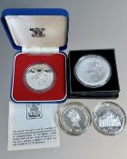 Silver proof coins including a crown, 5 Dollars and 5 Pounds.