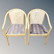 A pair of Scandinavian tub arm chairs in a natural finish