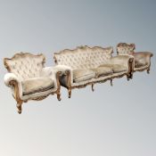 A three piece Baroque-style carved beech lounge suite in buttoned dralon