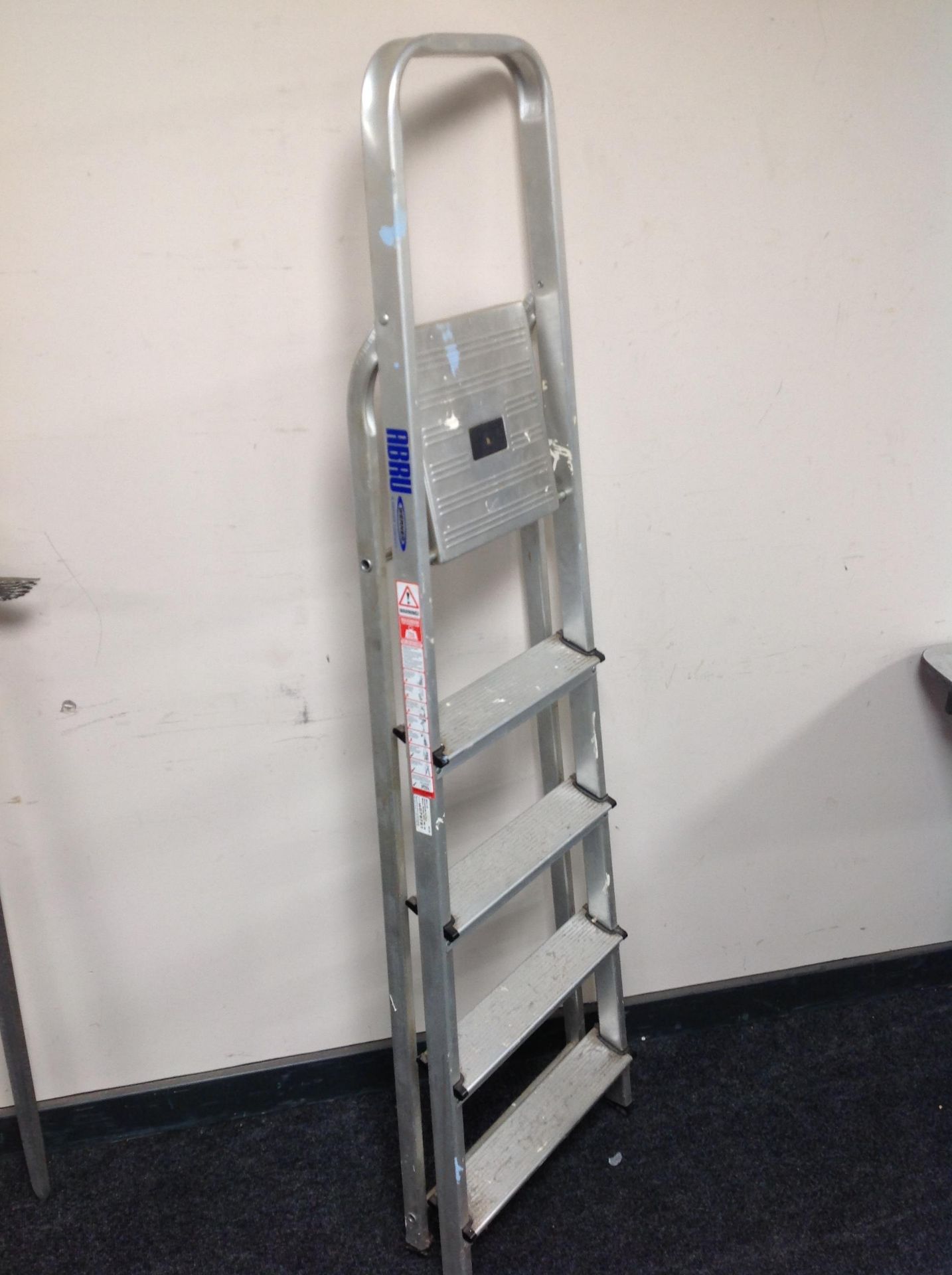 A folding aluminium five tread step ladder
