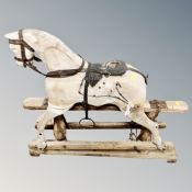 An antique wooden rocking horse, height 82 cm x length 93 cm.