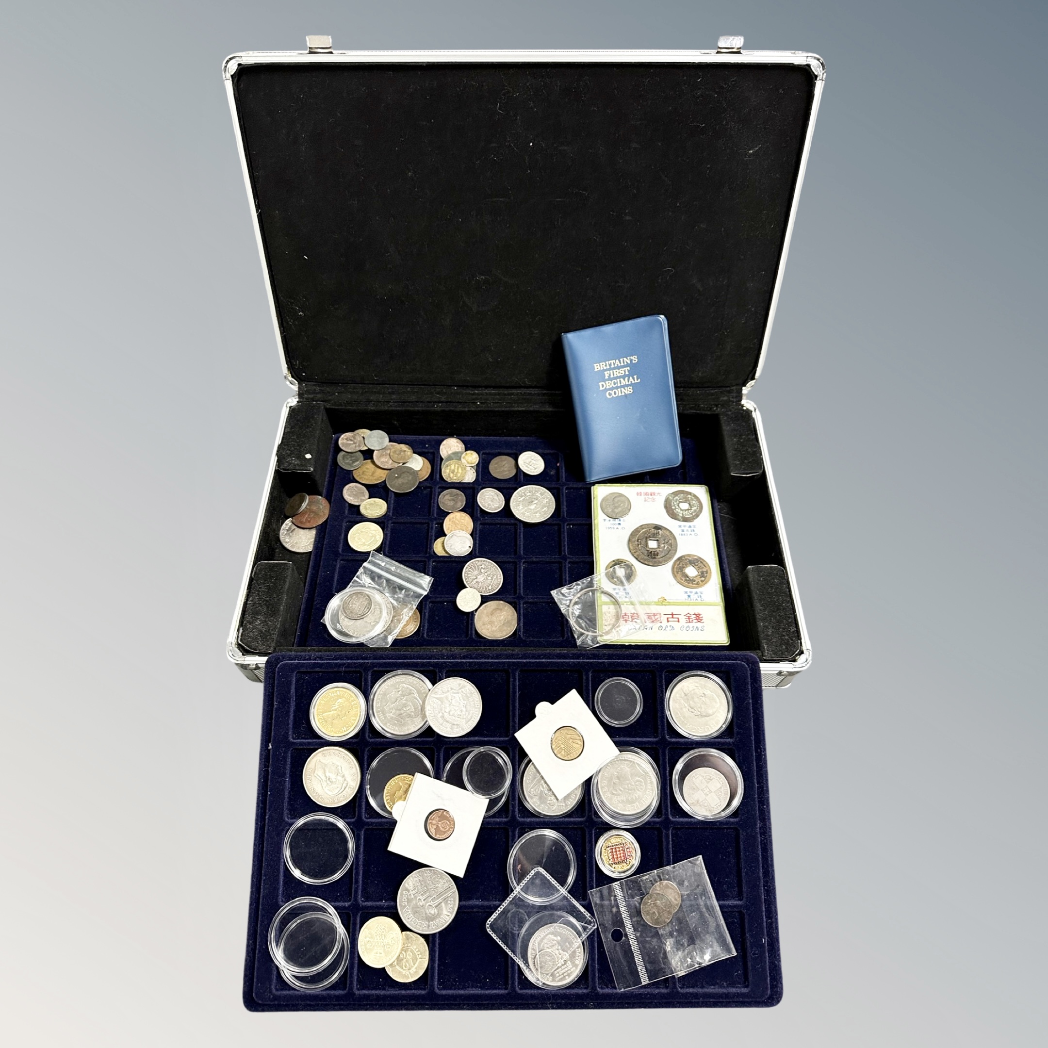 An aluminium coin case containing antique and later coins, some silver,