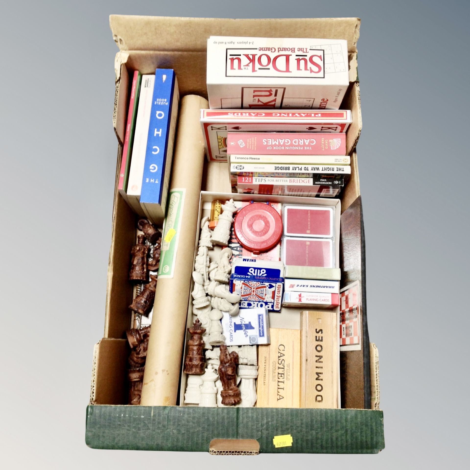 A box of chess board and pieces, Flippin cricket in card tube, playing cards, dominoes,