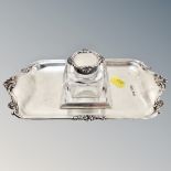 A silver-topped glass inkwell on silver stand,