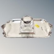 A silver-topped glass inkwell on silver stand,