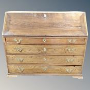 A 19th century oak bureau fitted with four drawers