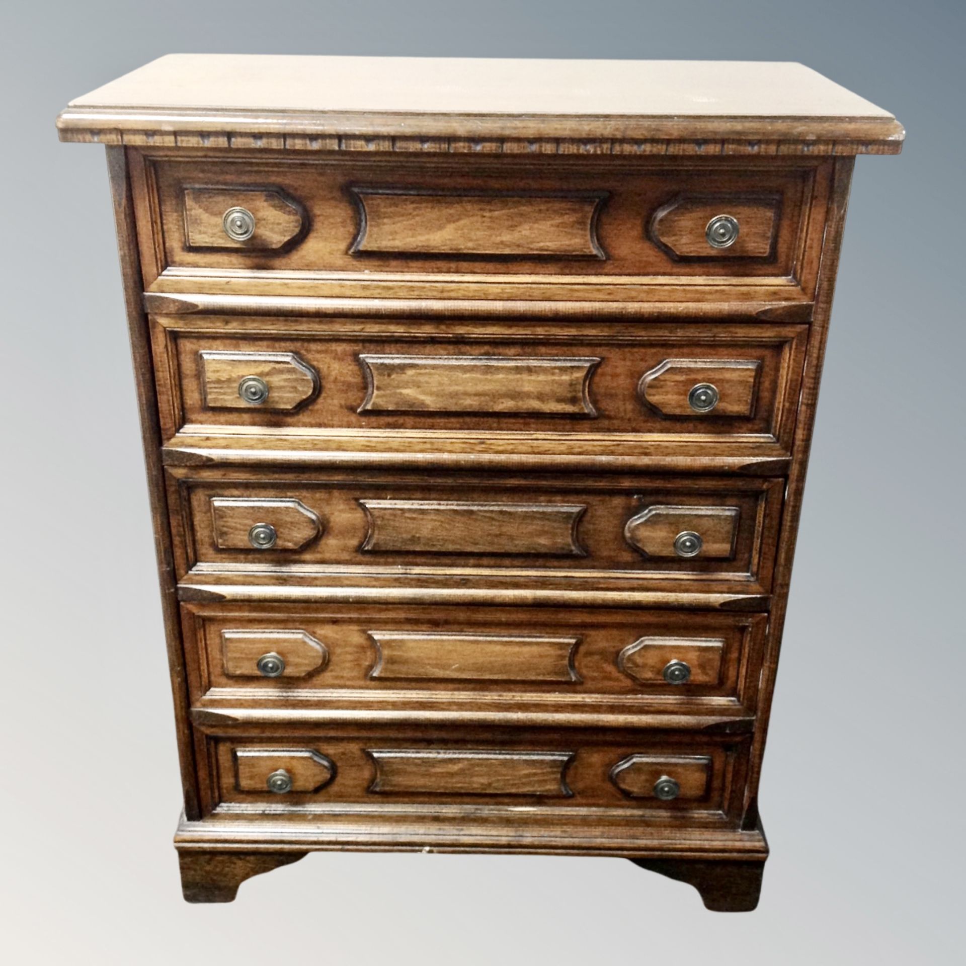 A stained beech five drawer chest