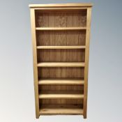 A set of contemporary oak open bookshelves