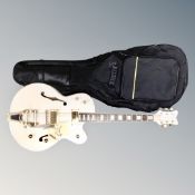A copy of a Gretsch Les Paul style electric guitar, cream,