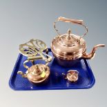 A tray of three graduated copper kettles,