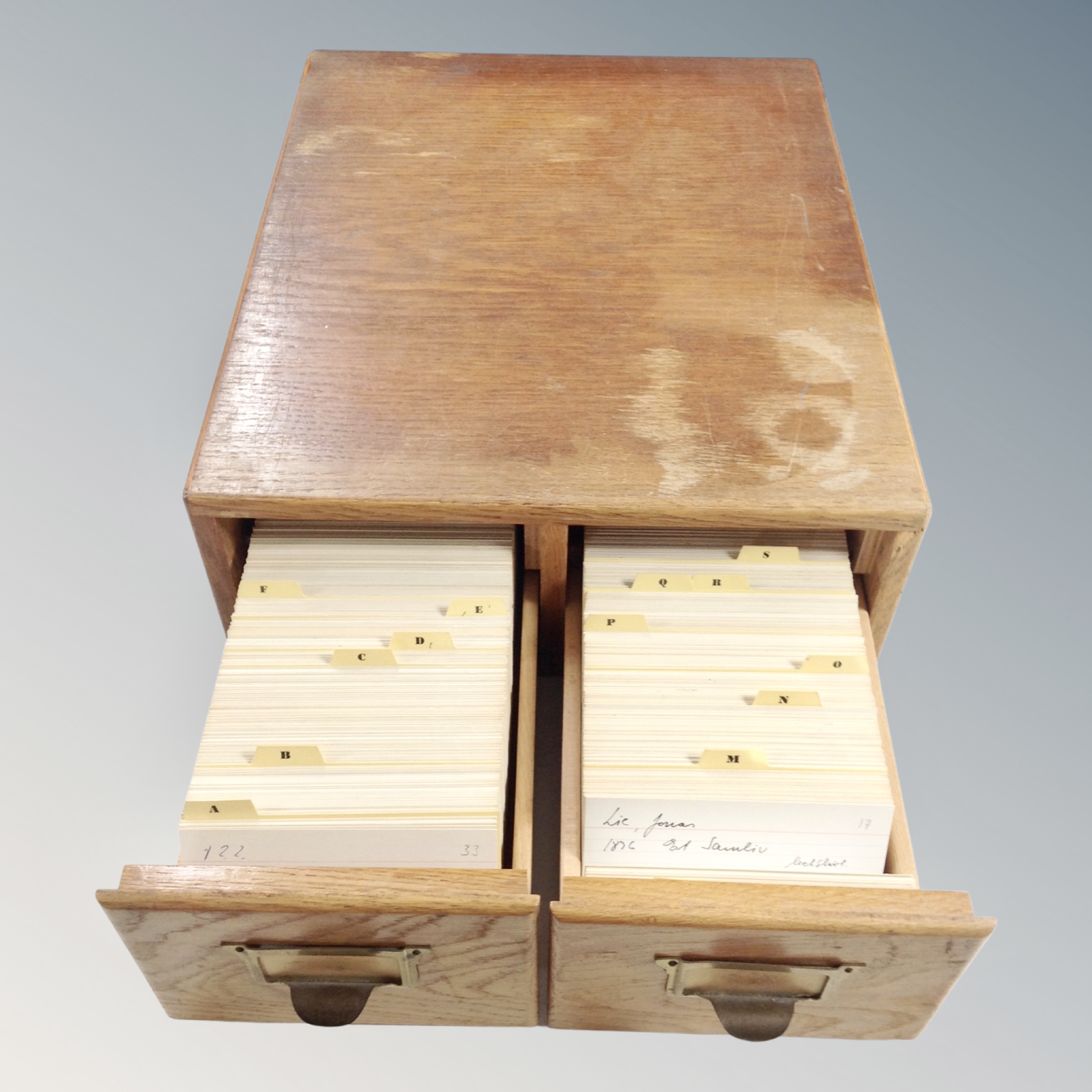 An oak two drawer index chest containing index cards