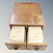 An oak two drawer index chest containing index cards