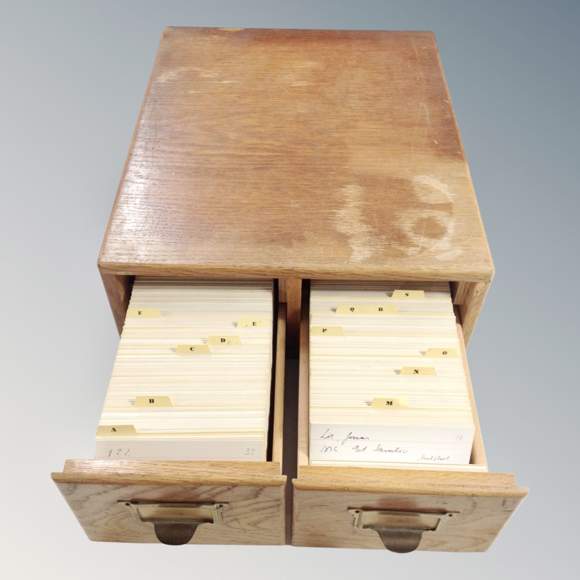 An oak two drawer index chest containing index cards