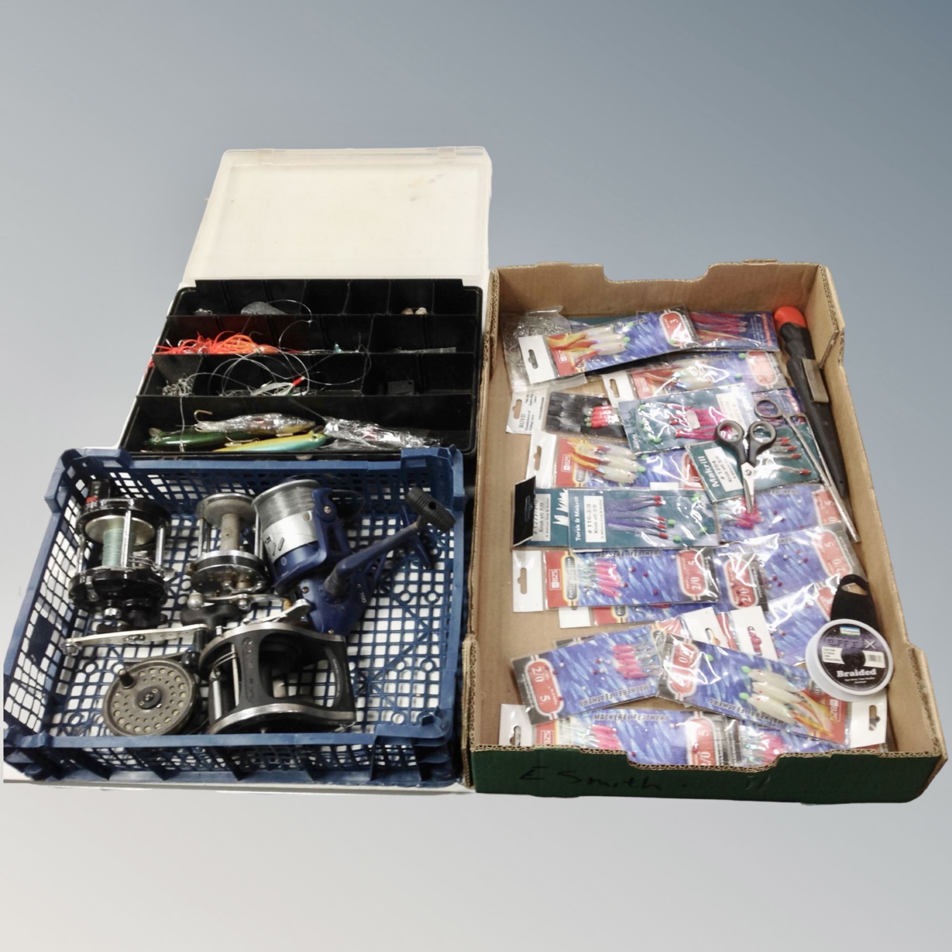 A box containing fishing reels, Commander by Penn, Crane Sports Beach 7000,