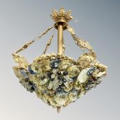 A vintage brass light fitting decorated with grapes and flowers