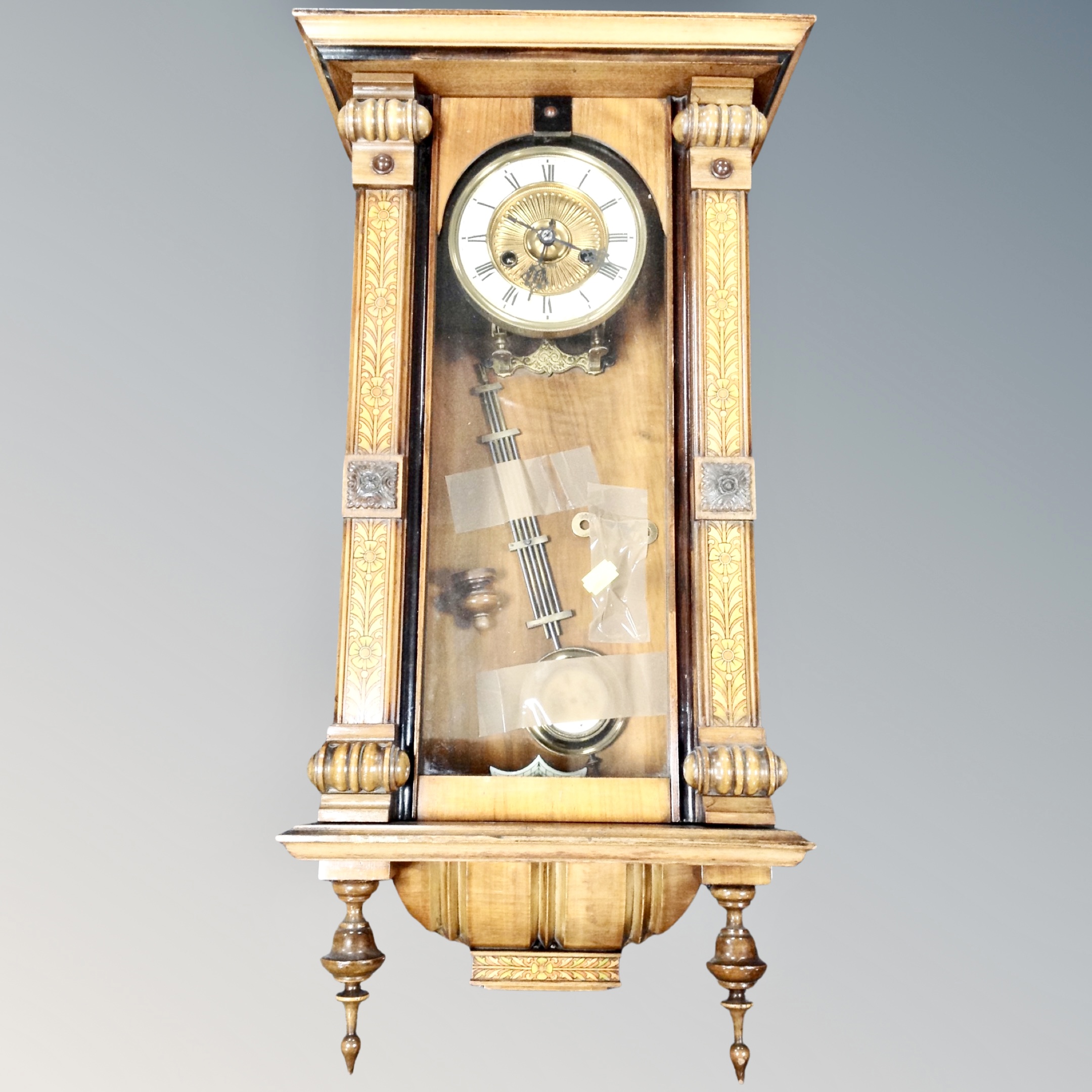 An inlaid eight day wall clock with enamel dial