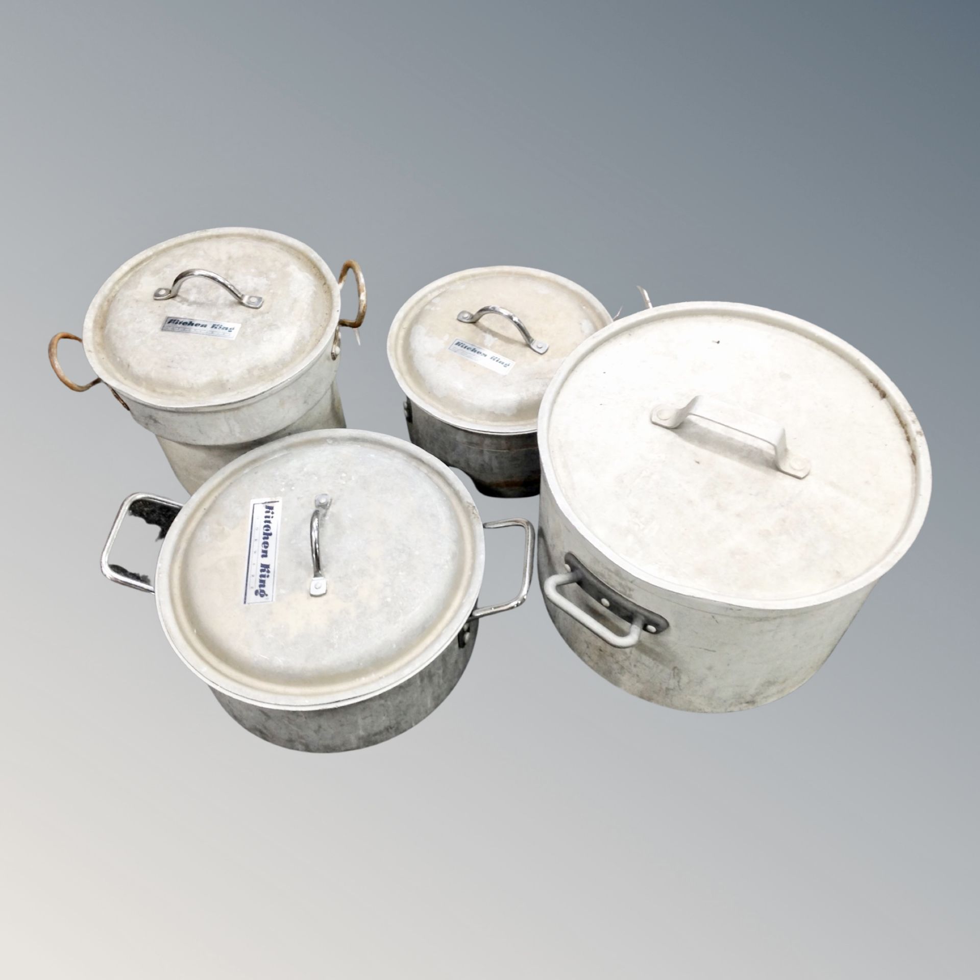 Four aluminium catering cooking pots with lids