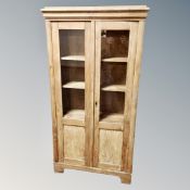 A 19th century pine double door glazed bookcase height 150 cm, width 80 cm and depth 22 cm.