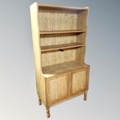 A Danish blond oak open bookshelf fitted with cupboards