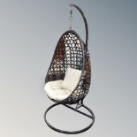 A rattan hanging egg chair with metal frame CONDITION REPORT: This is grey in