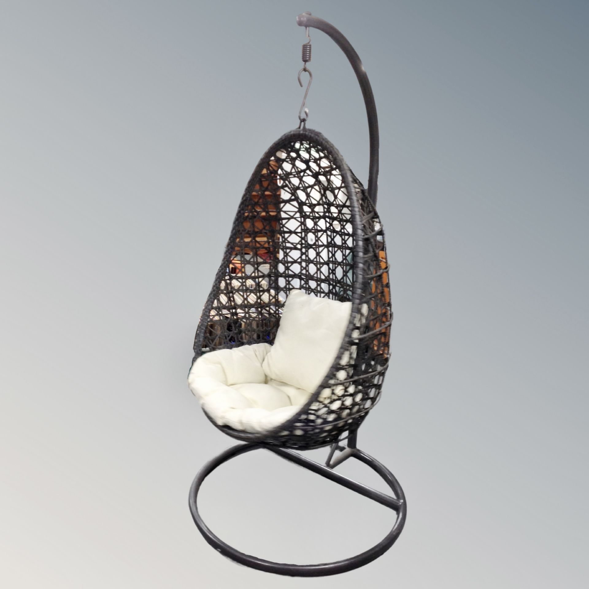 A rattan hanging egg chair with metal frame CONDITION REPORT: This is grey in