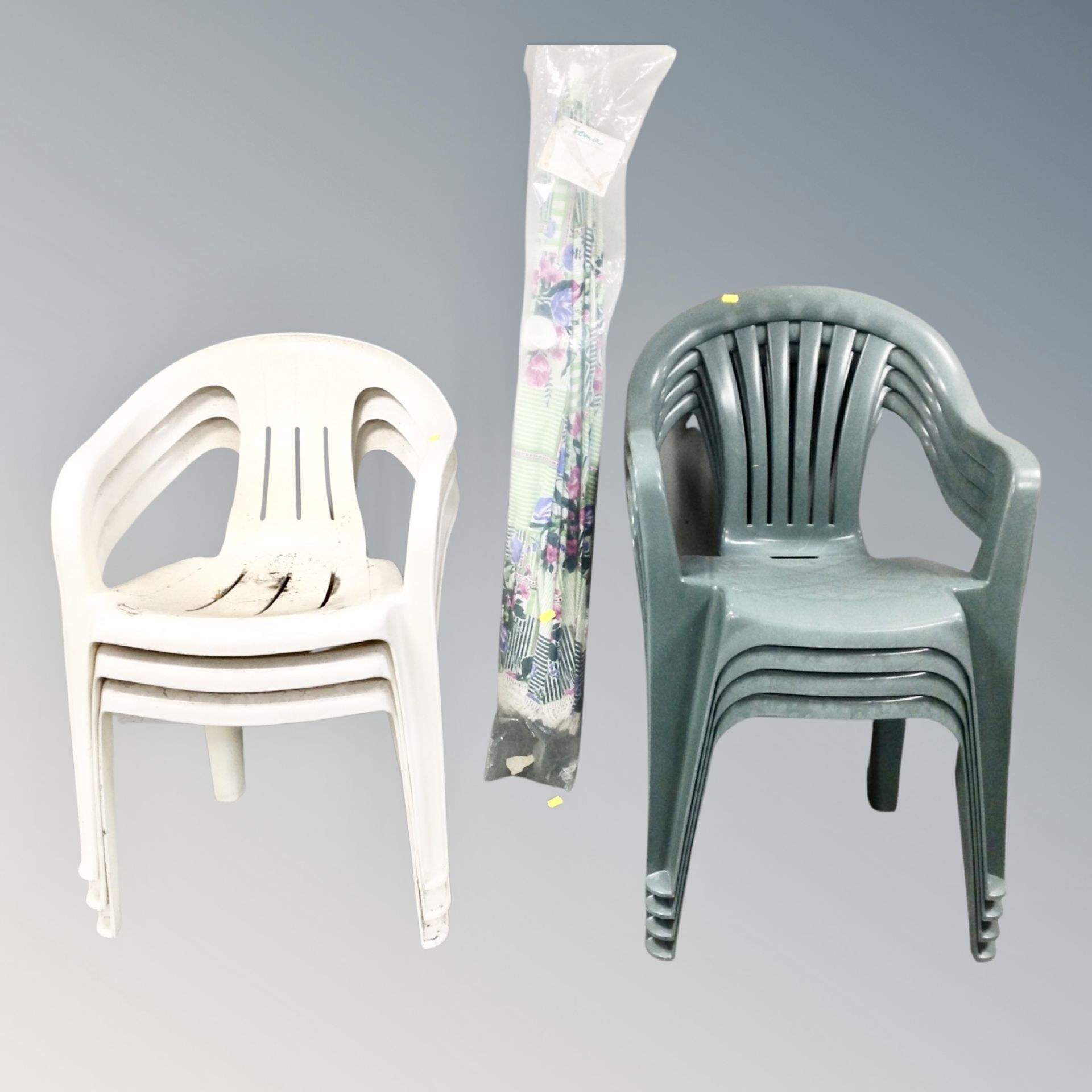A set of four plastic stacking garden chairs together with a set of three stacking plastic chairs,