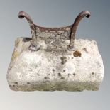 A 19th century cast iron boot scraper on weathered stone stand
