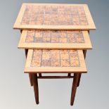 A nest of three 20th century Danish teak tiled coffee tables
